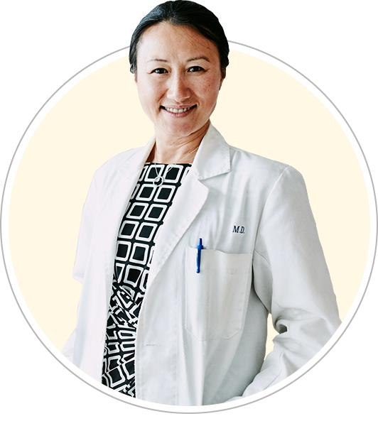 A female rheumatologist in a white coat.
