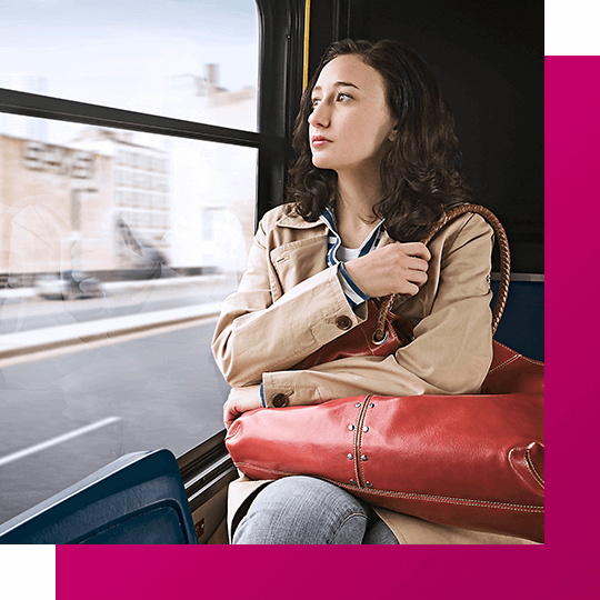 Person on train clutching purse as they look outside